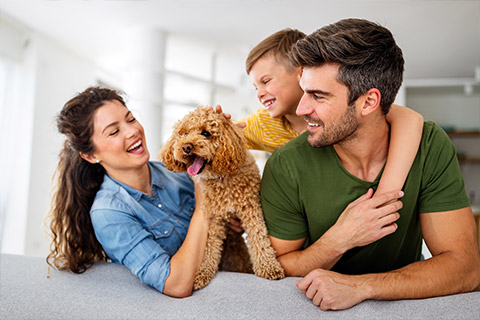 A family and their dog sitting together in their home